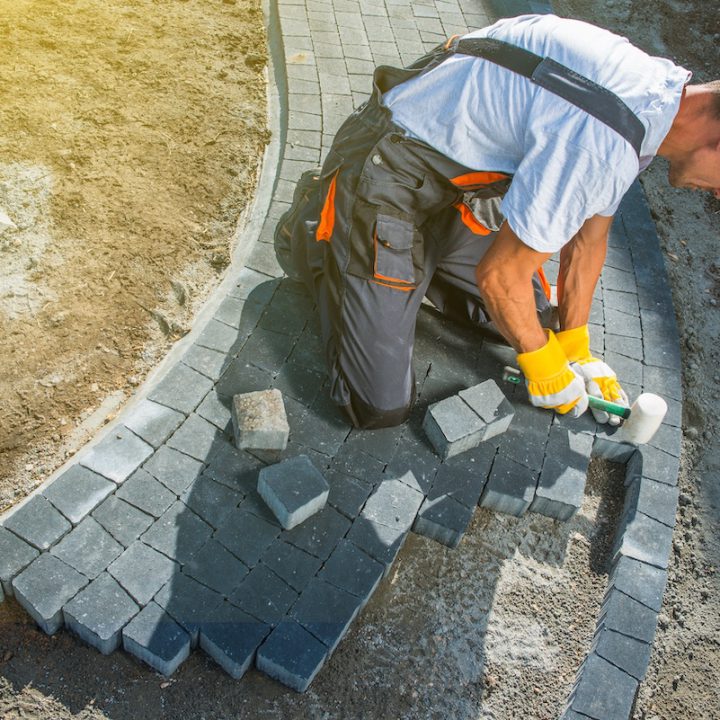 Brick Paving Works. Professional Caucasian Worker Building Block Paved Hardstanding Garden Path